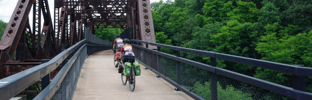 two riders over a bridge on the GAP trail