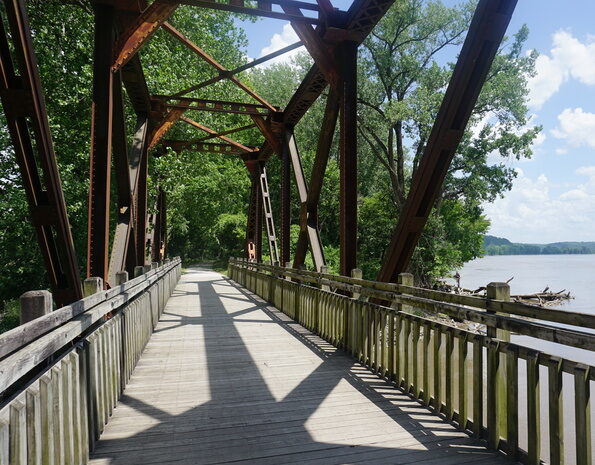 Old bridge with lake in background on Katy Trail, MO