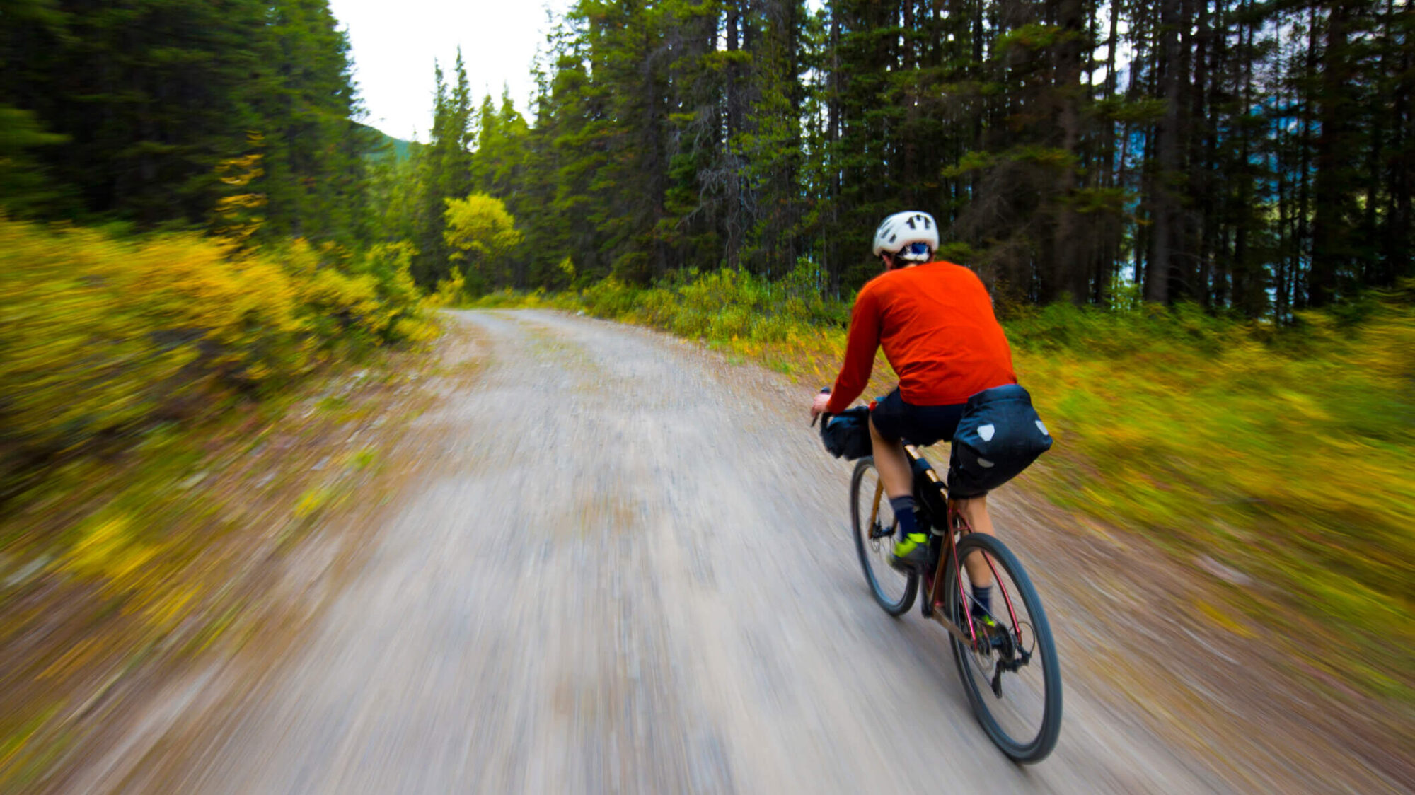 a man self-guided biking on gravel road